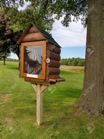 log cabin library on wooden post